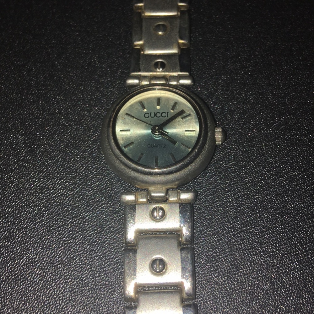 silver gucci watch w/ blue face